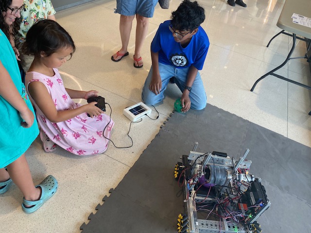 A young visitor trying the Techs Mechs robot at the Texas 4-H Open House
